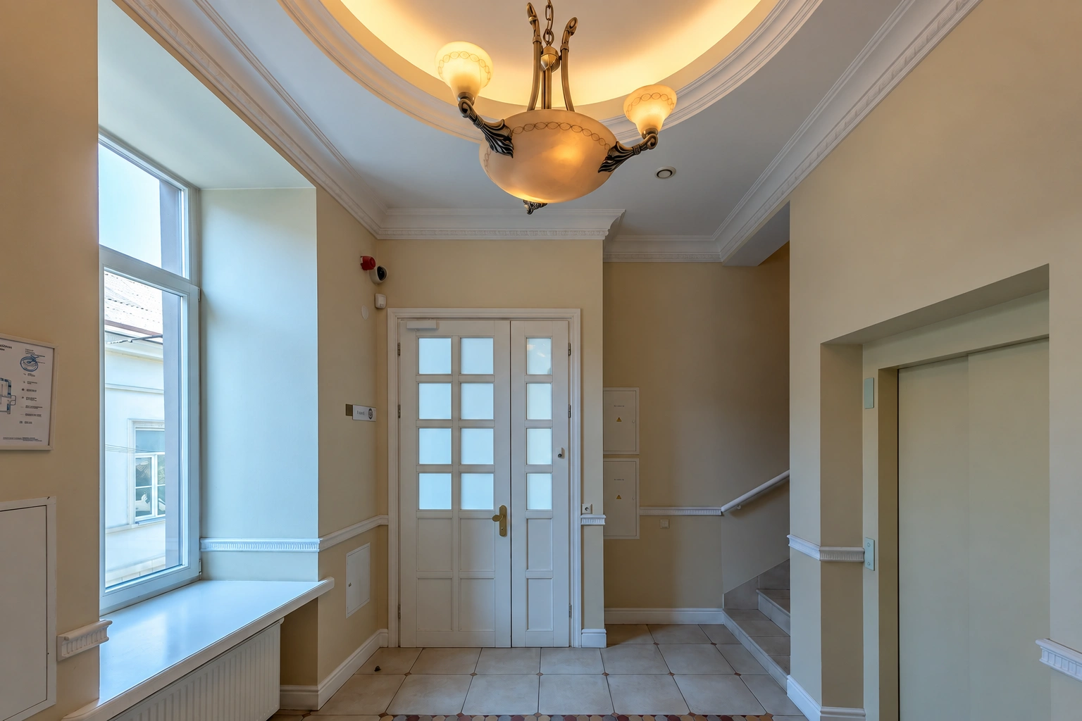 Entrance area with glazed doors and stairs leading up on the right.