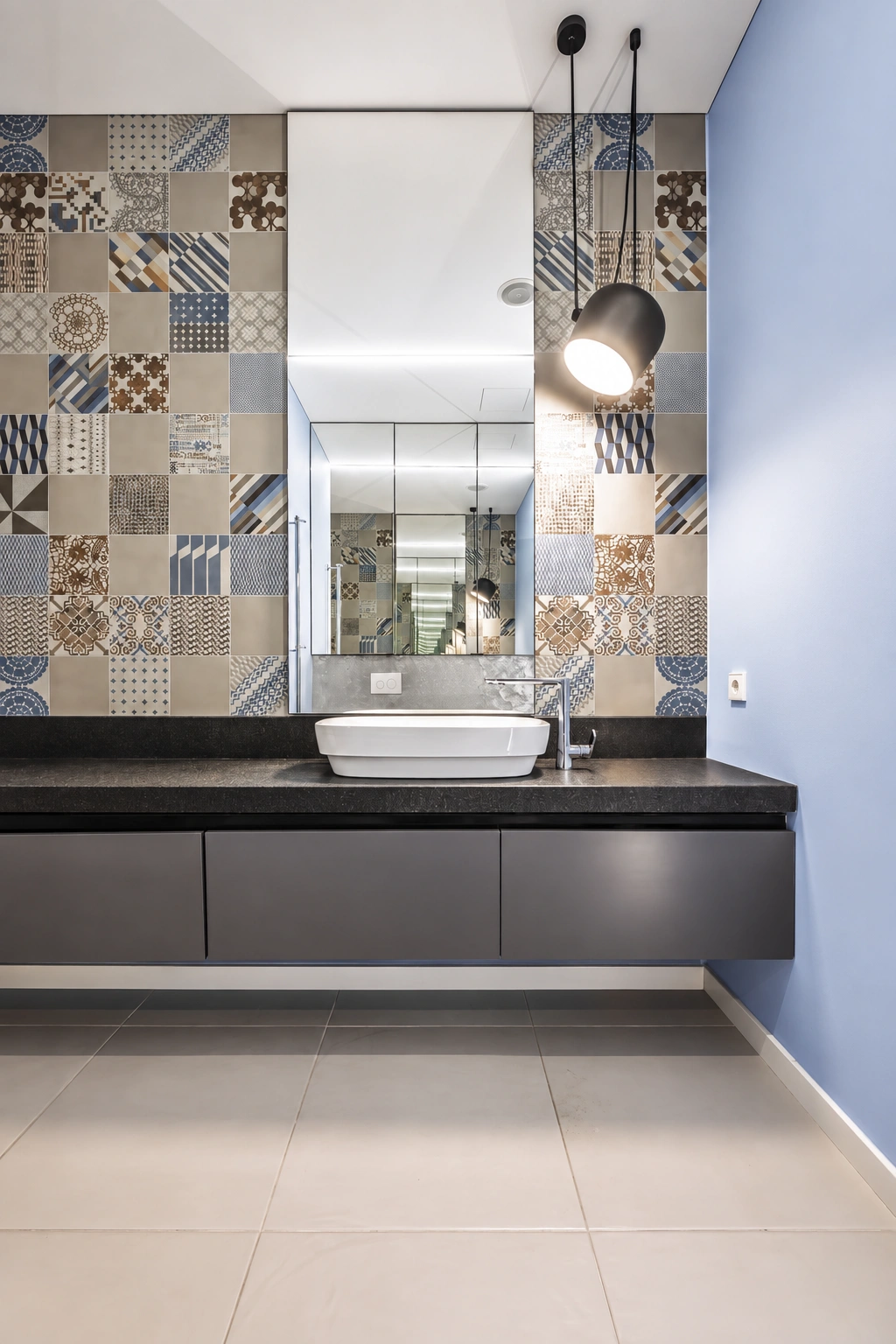 A mirror is mounted above the washbasin with a dark cabinet, and a black light fixture hangs beside it.