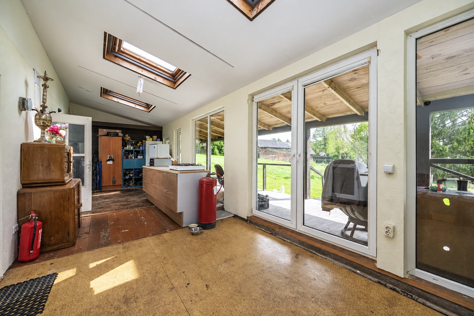 A room with skylights and large glass doors to the terrace.