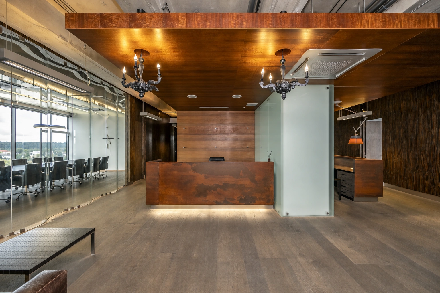 A room with a wide counter and light fixtures hanging from the ceiling.