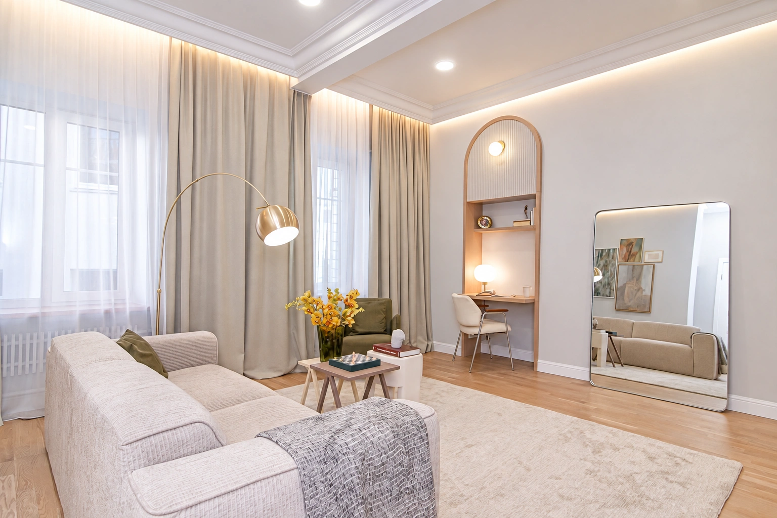 A living room with a light-colored sofa and large windows covered by long curtains.
