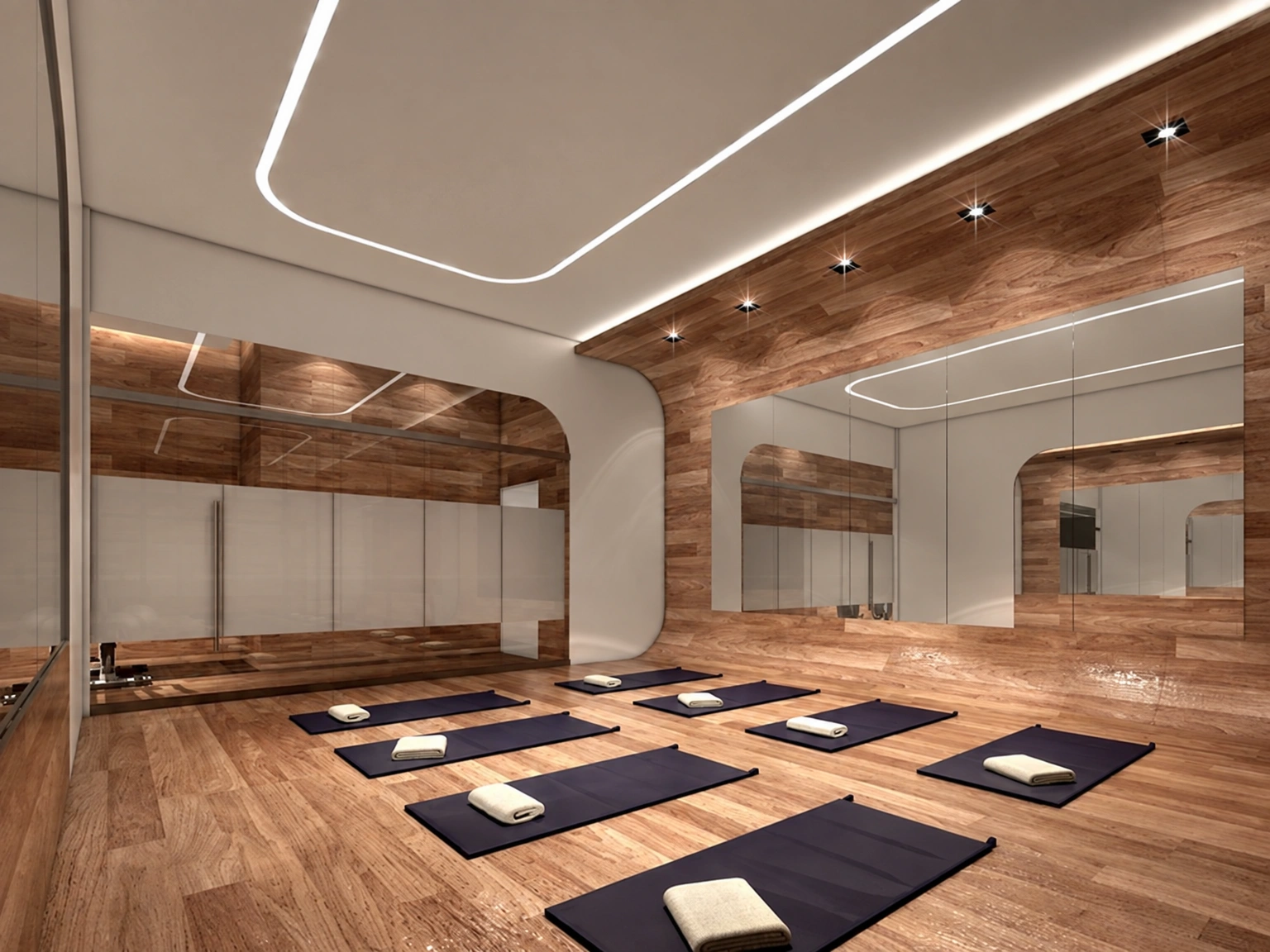 A room with mirrored walls and exercise mats laid out on the floor.