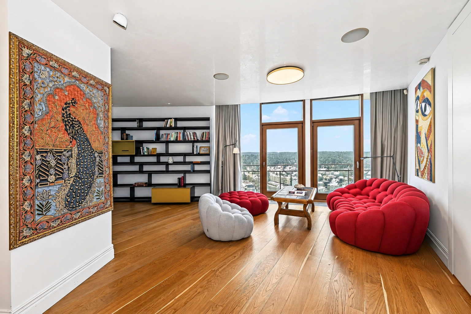 Wohnzimmer mit roten Polstermöbeln und großen Fenstern.