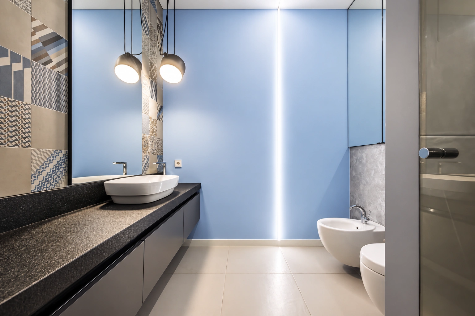 In the bathroom, a washbasin on a dark countertop and a wall-hung toilet are visible.